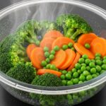 Brightly-colored-steamed-vegetables-broccoli-carrots-in-a-covered-glass-bowl-retaining-their-freshness.
